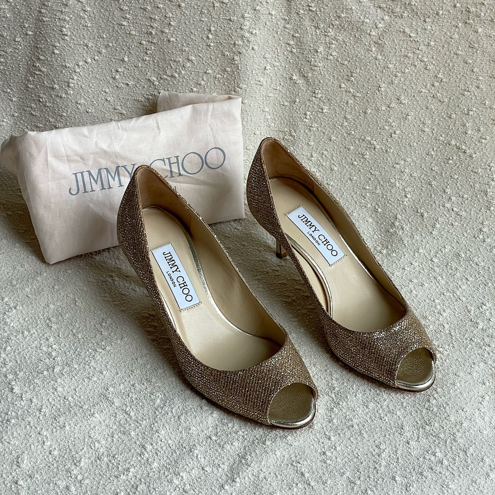 Jimmy Choo peep toe pumps in gold.